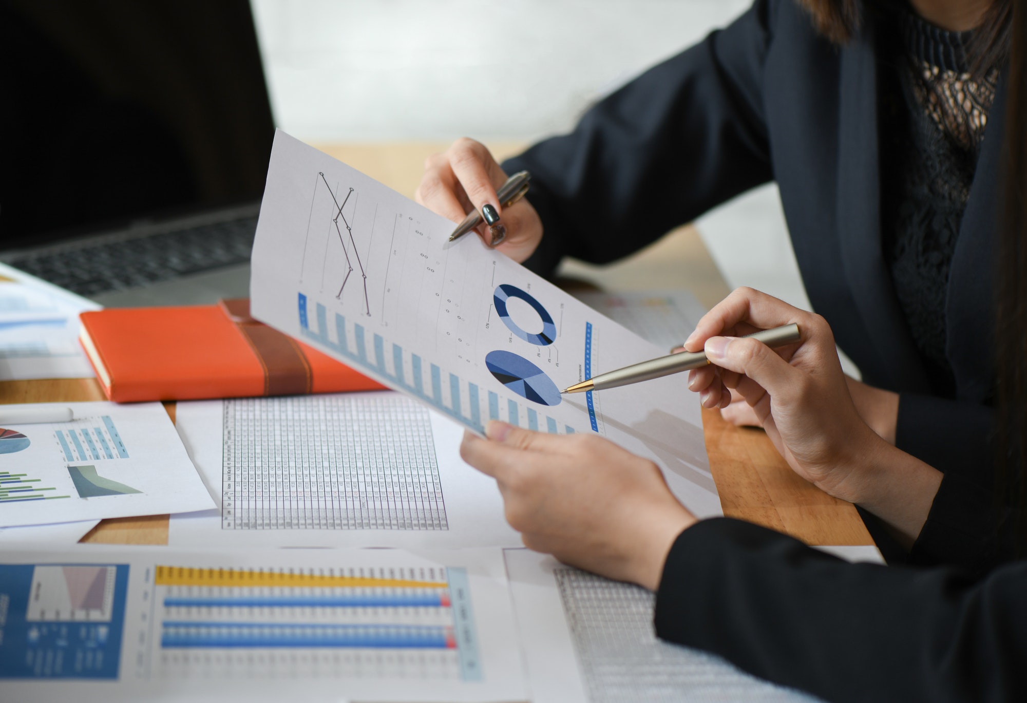 Female accountant team is analyzing data documents in the office.jpg